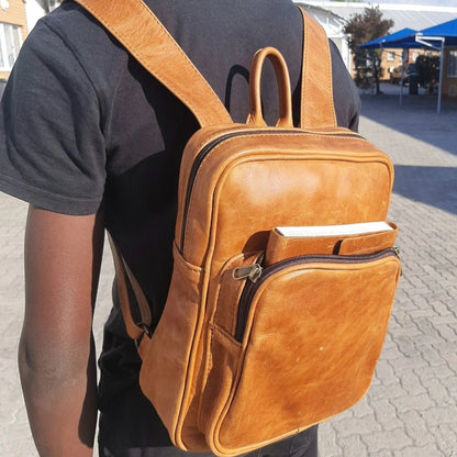 A teenager carrying diesel toffee tan Everyday backpack from Cape Masai Leather.