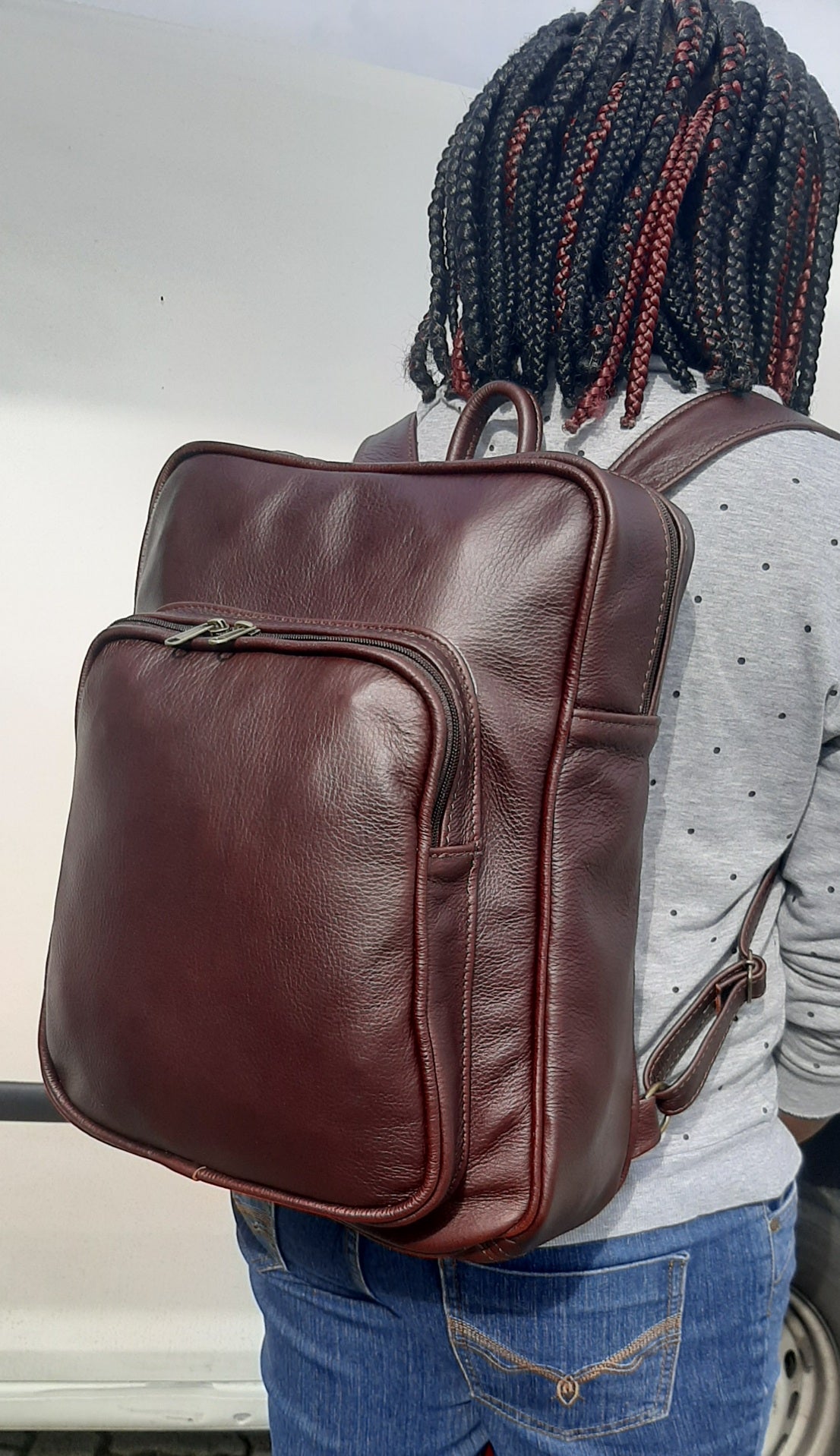 A beautiful African lady carrying a beautiful genuine leather backpack from Cape Masai Leather. 