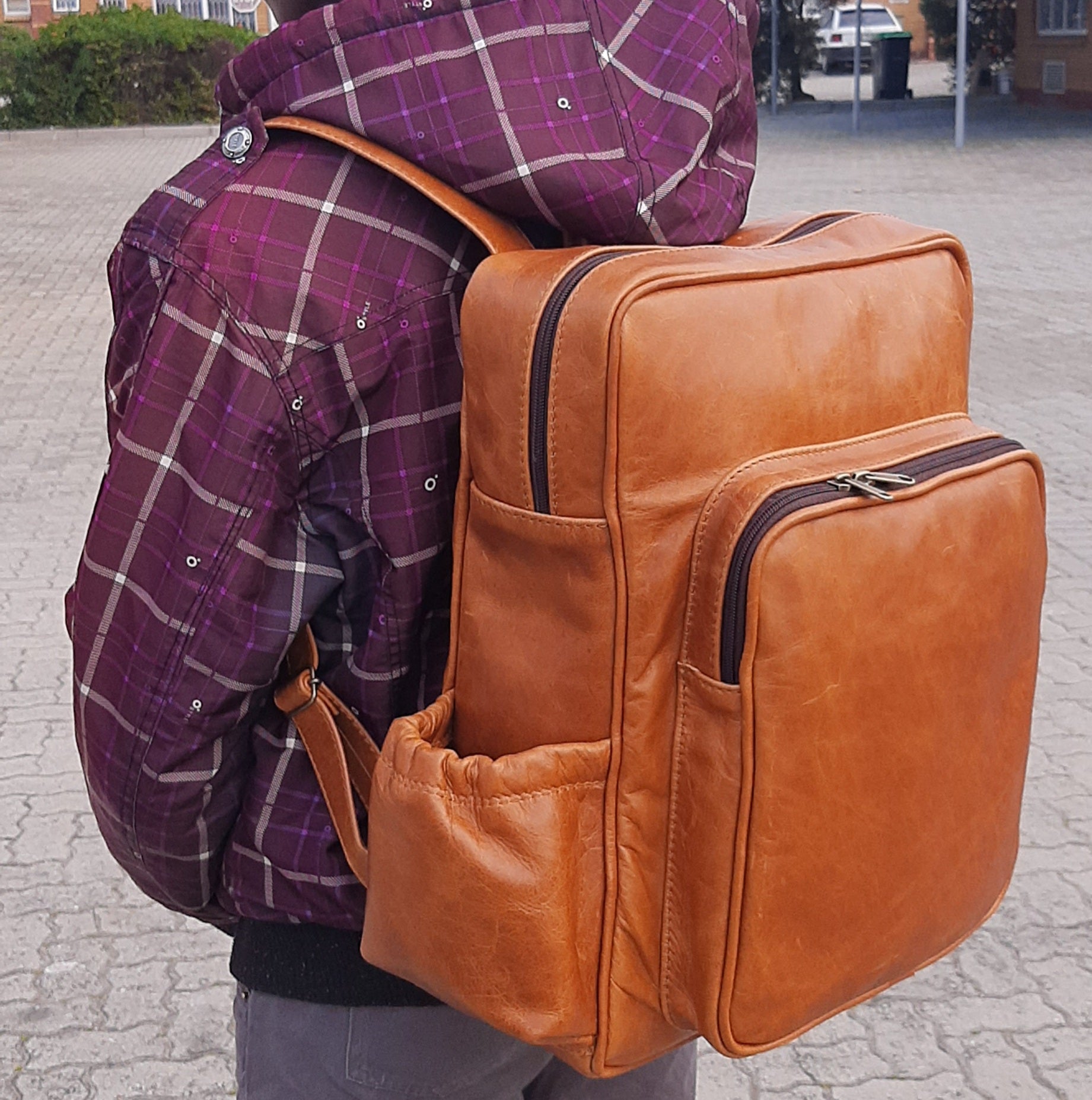 A boy carrying Everyday Leather Backpacks XL in light tan colour from Cape Masai Leather 