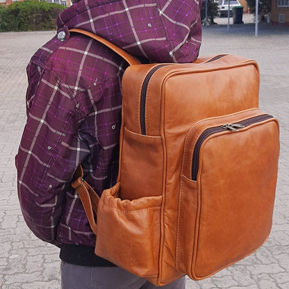 A boy carrying Everyday Leather Backpacks XL in light tan colour from Cape Masai Leather 