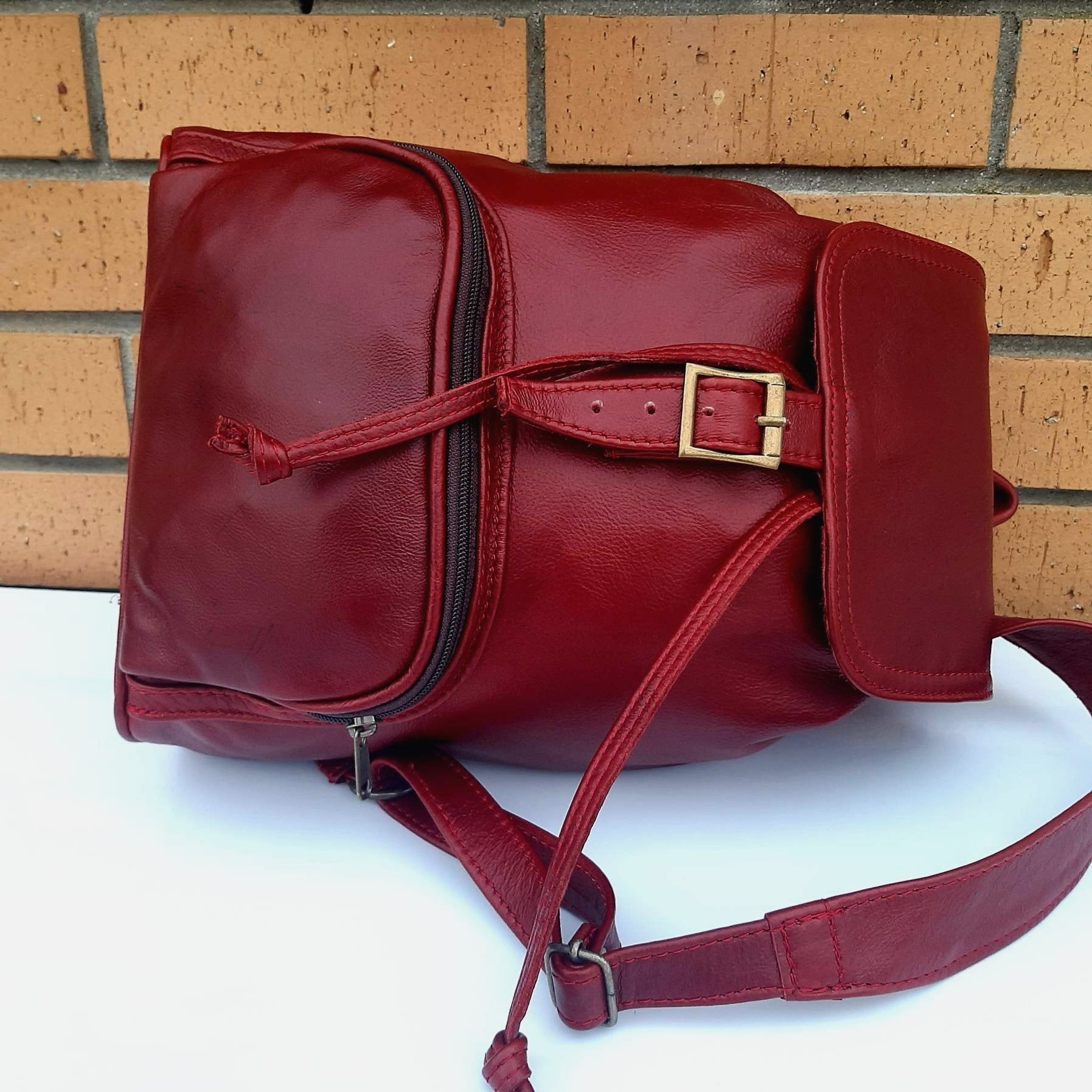 leather backpacks flap in cherry red  colour made by Cape Masai Leather
