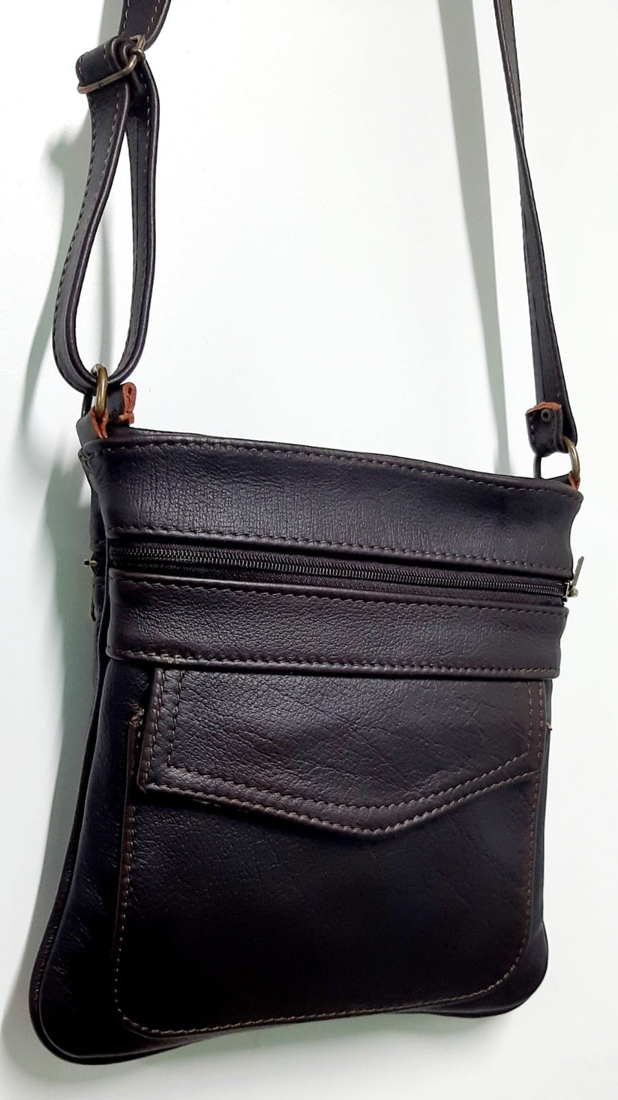 A beautiful genuine leather Leony sling bag hanging at Cape Masai leather factory shop 