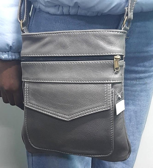 A lady carrying a beautiful genuine leather leony sling bag in gray from Cape Masai Leather 