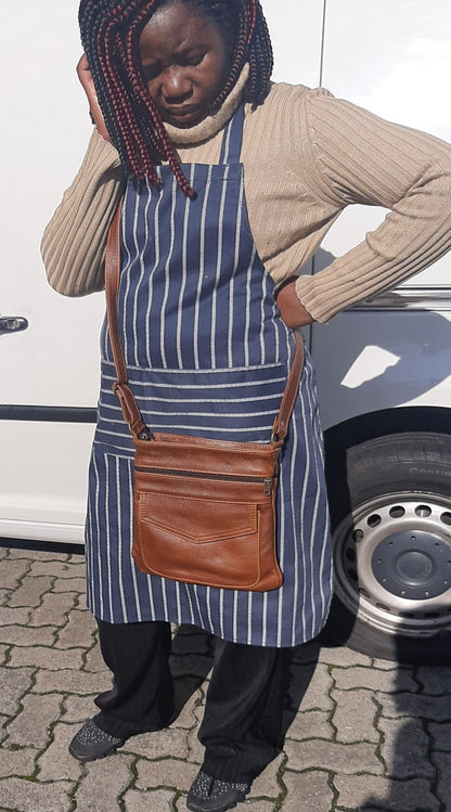 A lady carrying a beautiful genuine leather Leony sling bag pecan tan from Cape Masai Leather 