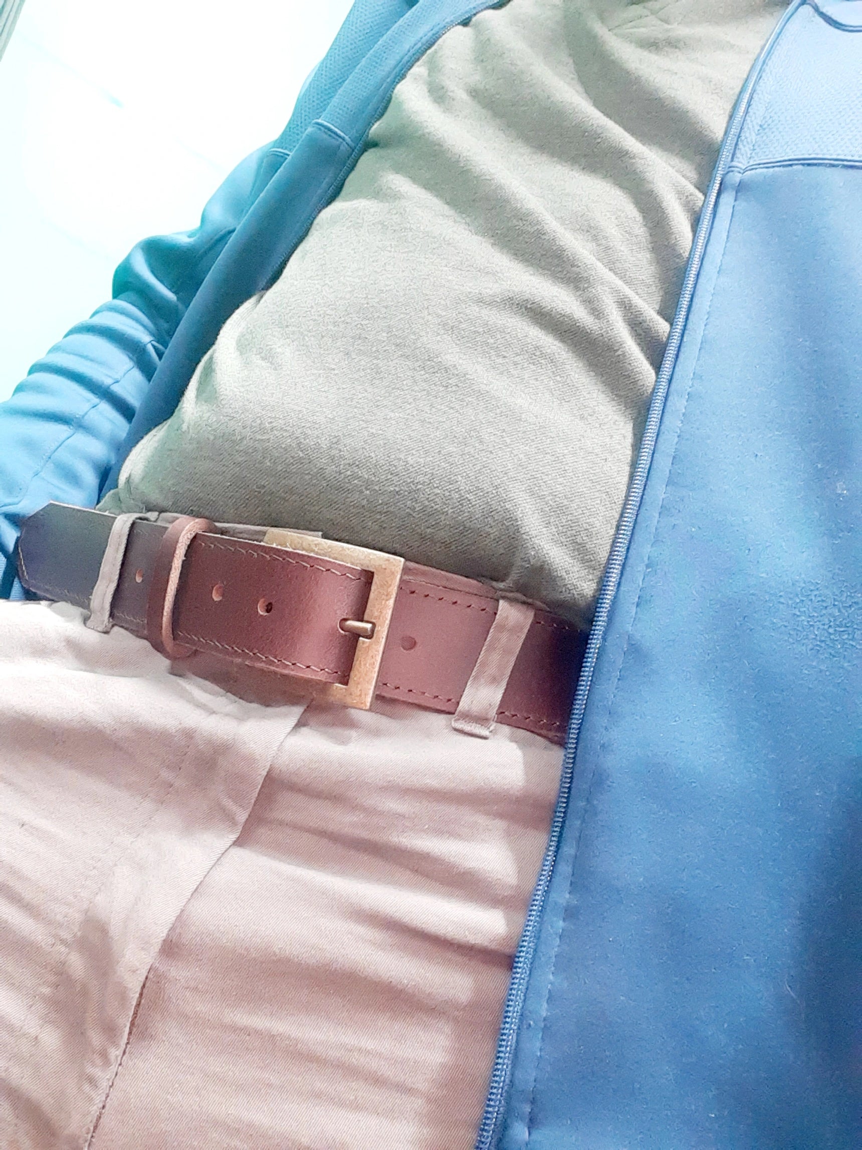 A gentleman wearing Masai genuine leather belts in Nickletin /Dark tan colour 