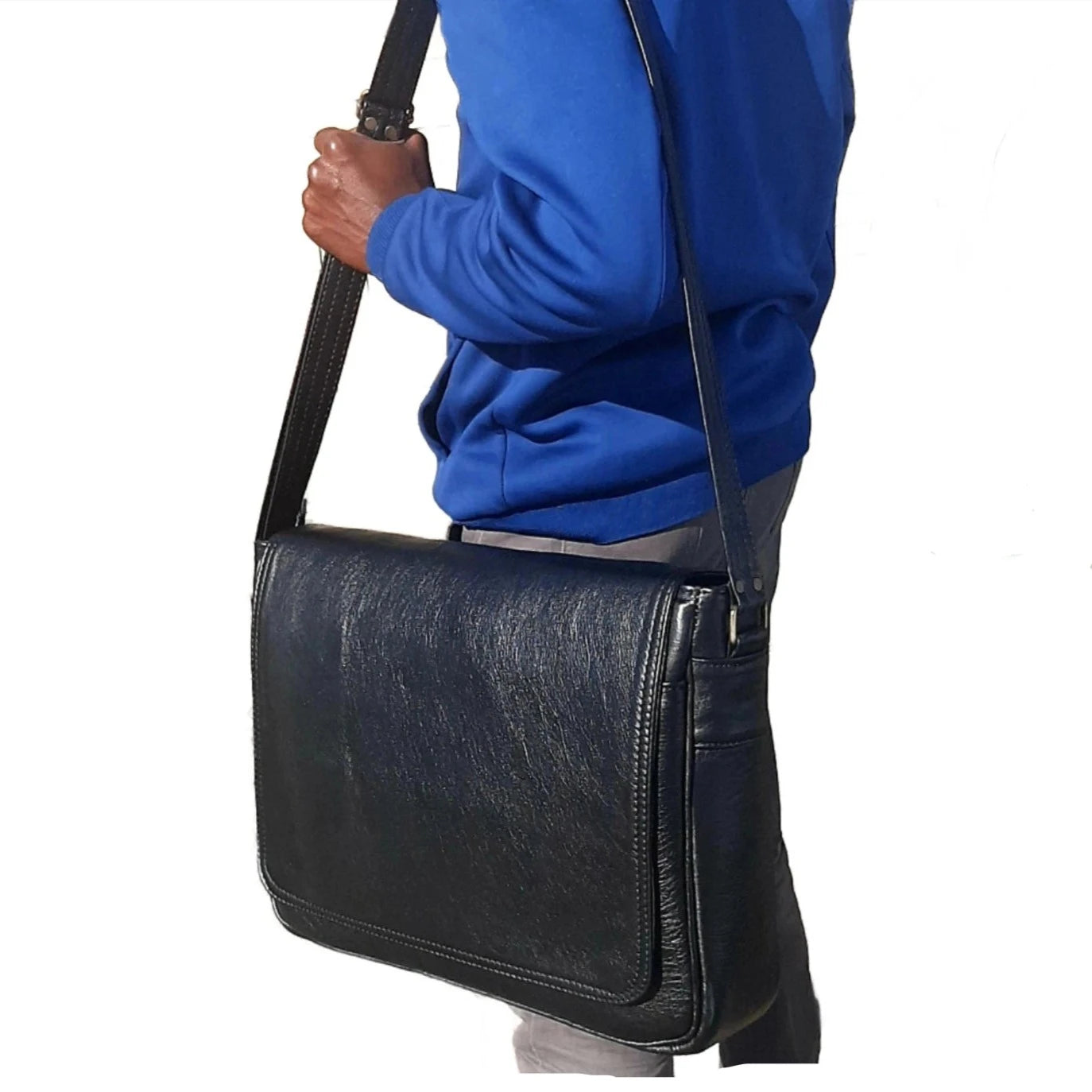 A young man carrying Men's laptop bag  15 - 15.6 inches black outside Cape Masai Leather 