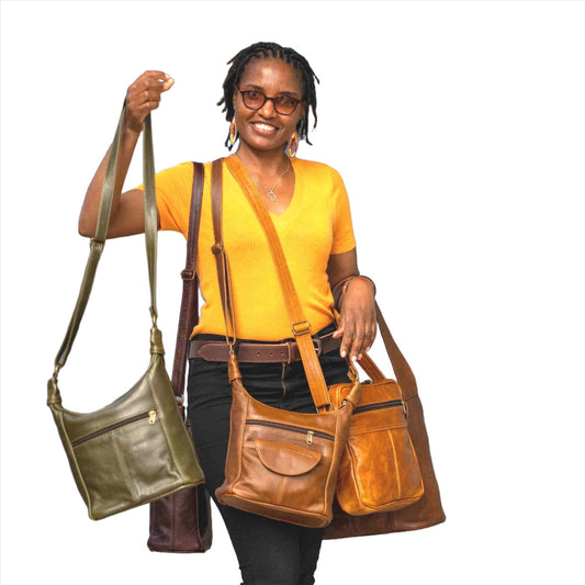 A Model carrying SH medium leather bags in olive green ans pecan tan colour from Cape Masai Leather