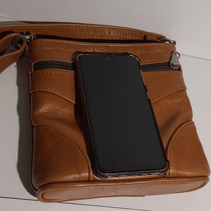 Sumsung Smart phone on a beautiful sling bag short at Viking Business Park to demonstrate size 