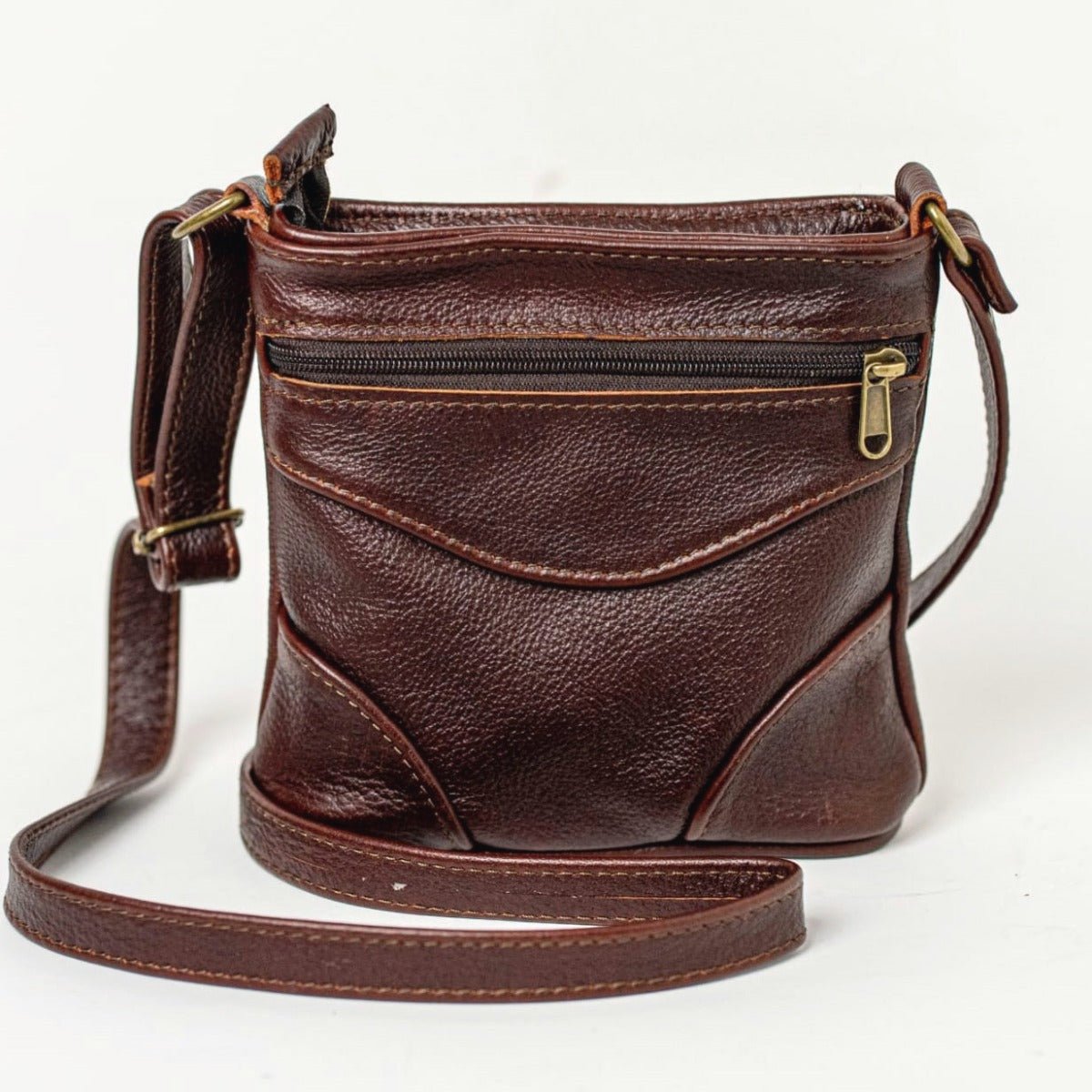  sling bag short in pecan tan standing on the floor