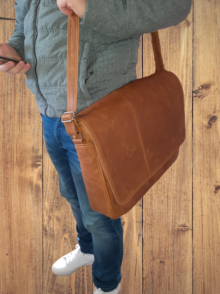 a man carry a Men's laptop bag 15" from Cape Masai leather 